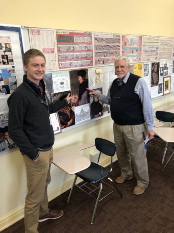 Staff Writer Aidan Shovlin and Mr. Lloyd point to Martin Luther on his classroom bulletin board.
