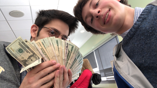 Senior Trevor Naman and Junior Henry Shaver count money after school after one of Student Governments fundraisers.