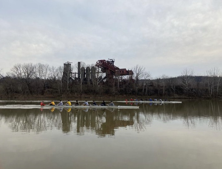 The Central Catholic Crew team rows past the Carrie Furnace along the Monongahela River