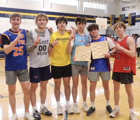 The winning Dodgeball tournament team is pictured holding their hand-carved bracket. 
